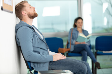 Patients waiting in a clinic waiting room representing care delays and capacity strain